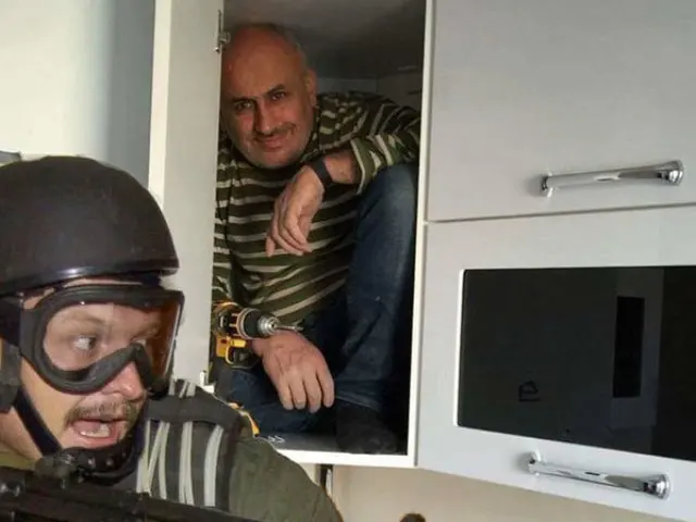 A man is hiding in a closet from a commando blank meme template